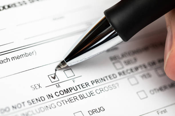 istock Person marking gender checkbox in a form 1342451204