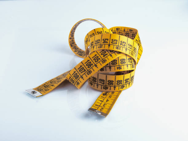 istock Yellow measuring tape isolated on white background. 1342457389