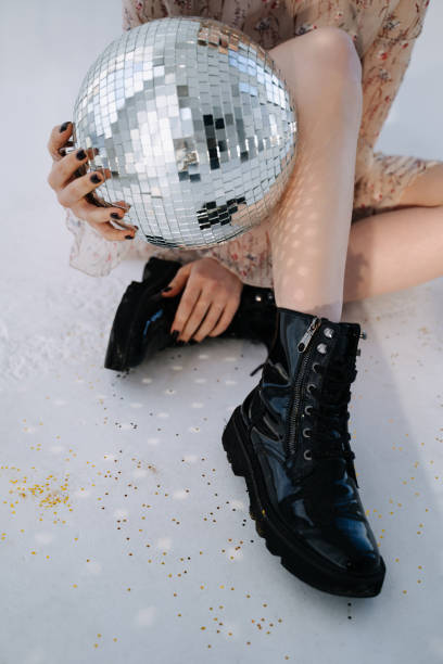 istock Disco Sphere Holding Girl on Celebrative Party 1342457536