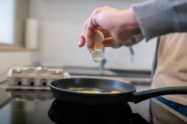 istock A gray-haired man cooking omlette in the kitchen 1342457829