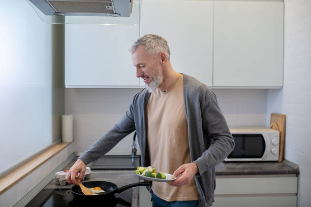 istock A mature beraded man cooking in the kicthen 1342457841