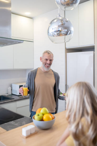 istock A mature man and his daughter talking in the kitchen 1342457943