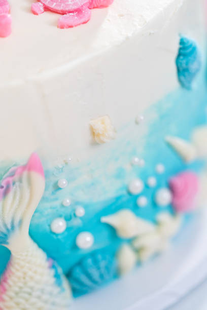 istock Mermaid-themed 3 layer vanilla cake decorated with chocolate mermaid tails 1342460463