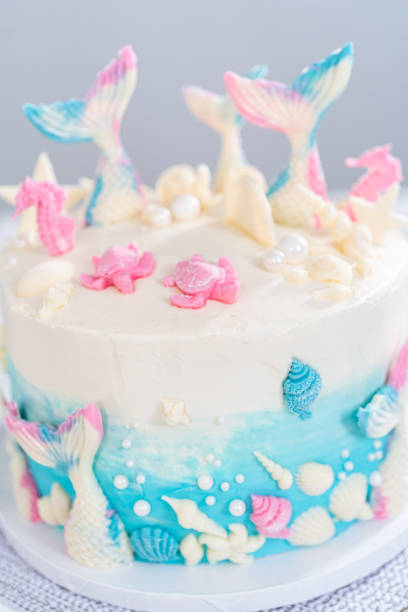 istock Mermaid-themed 3 layer vanilla cake decorated with chocolate mermaid tails 1342460577