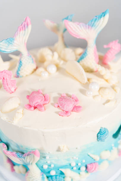 istock Mermaid-themed 3 layer vanilla cake decorated with chocolate mermaid tails 1342460656