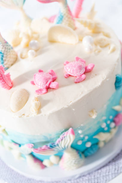 istock Mermaid-themed 3 layer vanilla cake decorated with chocolate mermaid tails 1342460811