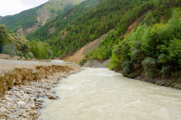 asphalt mountain road and river in the gorge stock photo