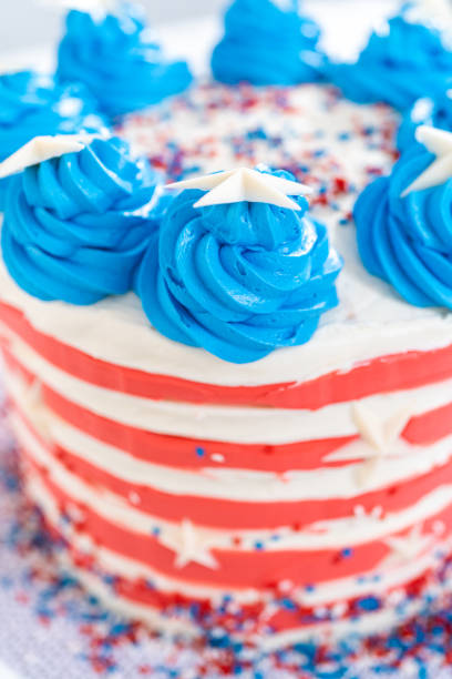 istock Decorating chocolate cake with white, red, and blue buttercream frosting 1342462093