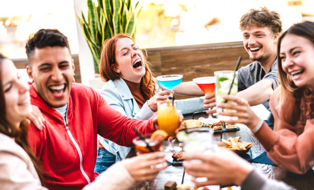 istock Friends toasting multicolored drinks at open air bar restaurant after work - Life style concept with people having fun together sharing cocktails on happy hour at terrace party 1342464812