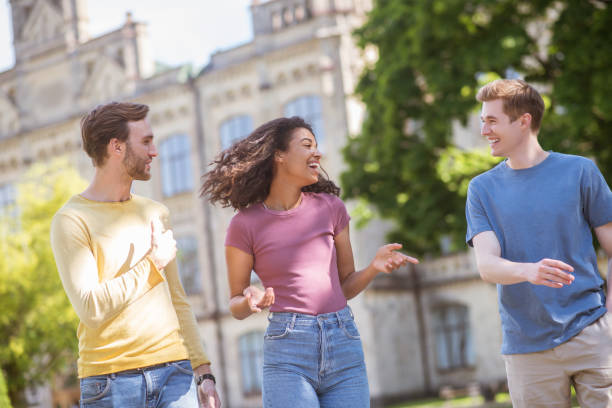 istock Three people walking in the park and discussing something 1342465971