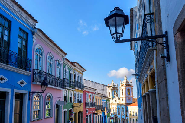 colorful colonial-style houses and a tower of an old baroque church in pelourinho - pelourinho imagens e fotografias de stock