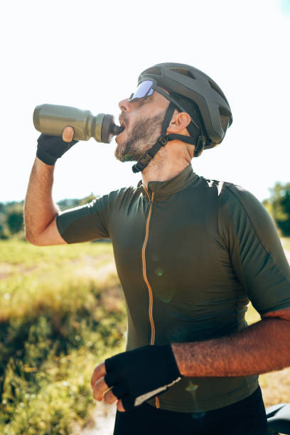 istock cyclist drinking water on the countryside 1342468390