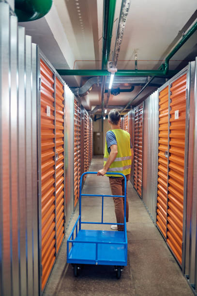 istock Back view of man with trolley in warehouse 1342469667