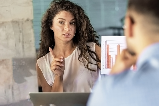 Multiracial startup business team with charts during a meeting at a coffee shop