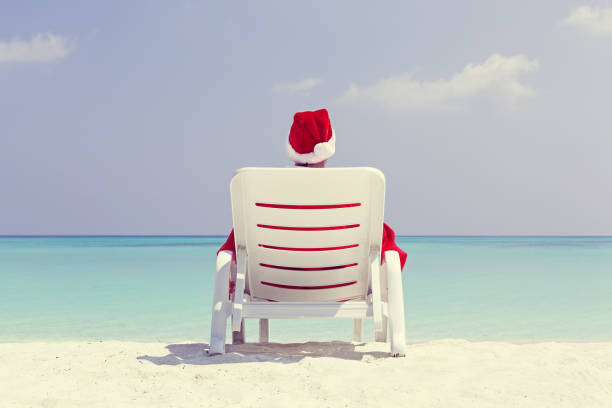 istock Santa Claus relaxing on sun bed, Christmas card 1342471312