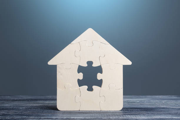 istock Puzzle house with a missing piece. The acquisition or construction comfortable dream home. Mortgage loan purchase real estate. Arrangement premises repair. Availability and cheapness. Finish building 1342472430