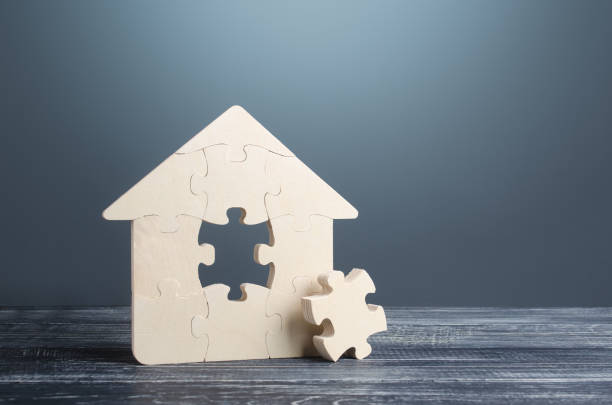 istock Puzzle house with a missing part. Housing construction, design and engineering. Mortgage loan for purchase real estate. During construction work. Reconstruction, renovation. Investments in building 1342472432