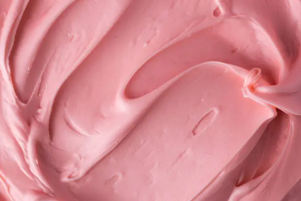 Photo of Pink icing frosting close up texture