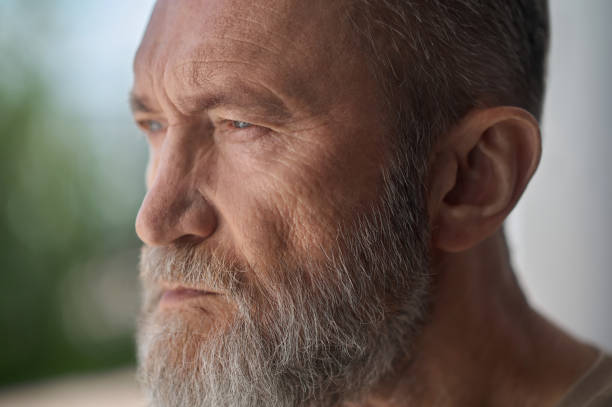istock Serious gray-headed man staring into the distance 1342473992
