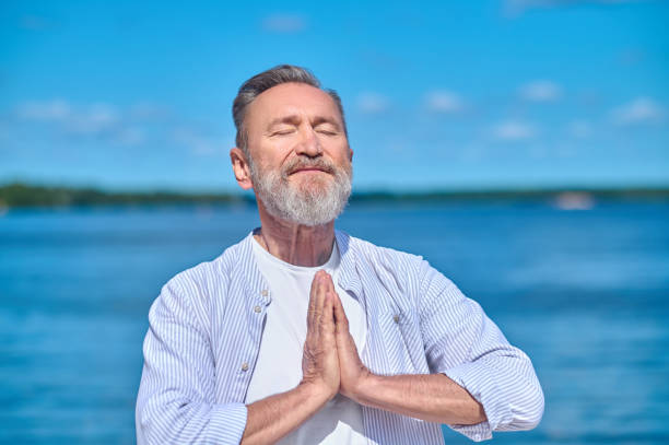 istock Man with closed eyes meditating in nature 1342474055