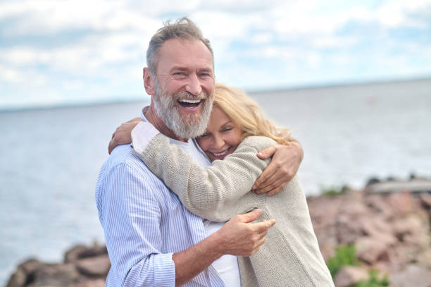 istock Delighted man hugging smiling woman outdoors 1342474093