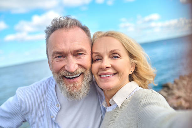 Smiling man and woman looking at camera