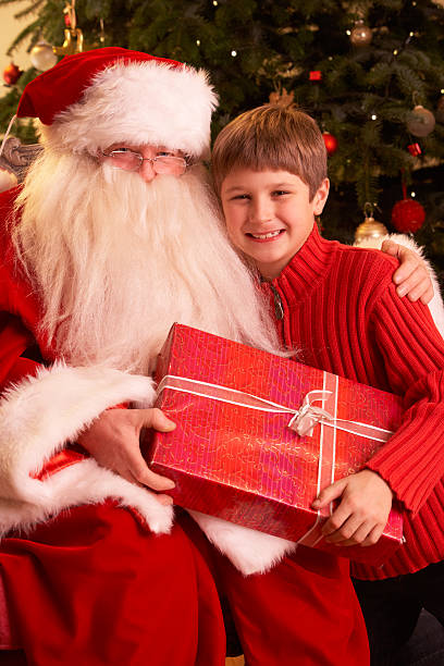 istock Santa Claus Giving Gift To Boy 134247565