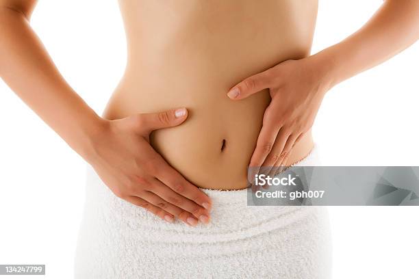 Woman With Both Hands On Belly Wearing Towel Below Waist Stock Photo - Download Image Now