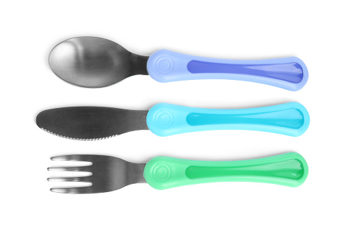 Set of small cutlery isolated on white, top view. Serving baby food
