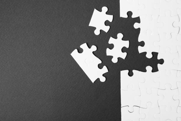 istock Blank white puzzle with separated pieces on black background, flat lay. Space for text 1342479011