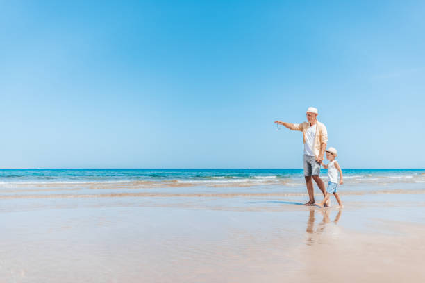 istock Caucasian father and son having fun on the beautiful sandy beach 1342479210