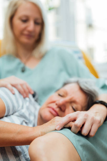 istock Senior mother rests in her daughter's lap 1342480030