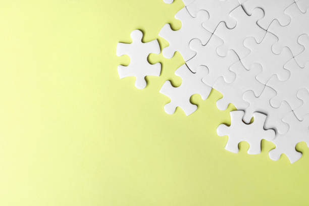 istock Blank white puzzle pieces on yellow background, flat lay. Space for text 1342480628