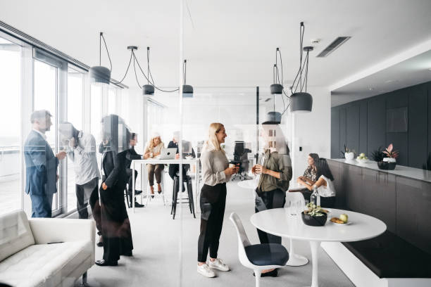 Corporate business people working in busy marketing office space, planning strategy in books and reading email on laptop at work. Businessman, businesswoman and workers at startup advertising company