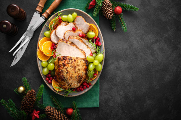 istock Christmas turkey dinner. Christmas turkey with decorations on black background, top view. 1342482038