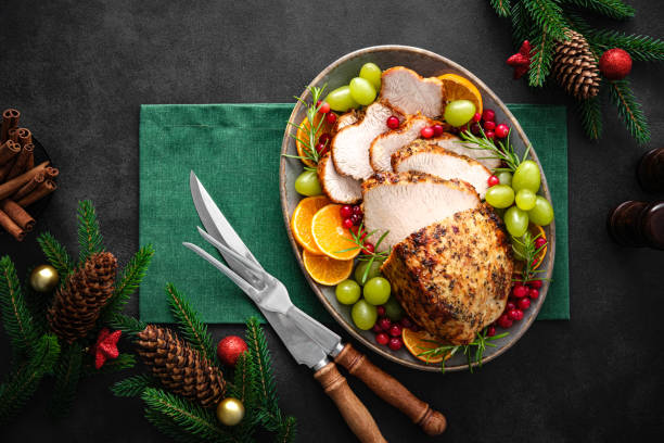 istock Christmas turkey dinner. Christmas turkey with decorations on black background, top view. 1342482044