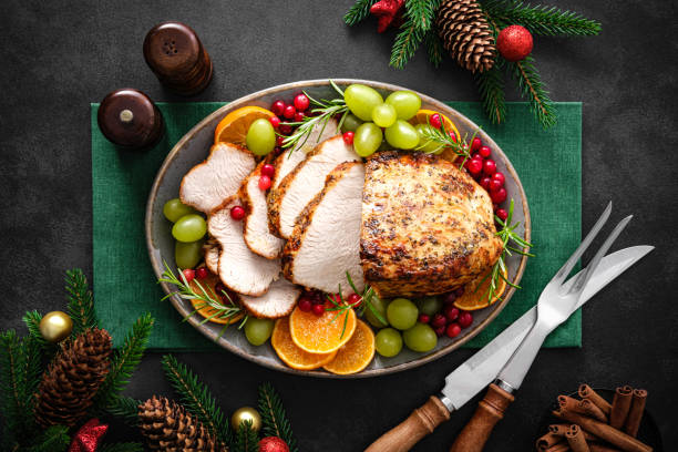 Christmas turkey dinner. Christmas turkey with decorations on black background, top view.