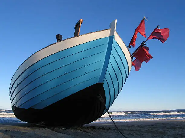 A fisher boat on the winter-beach of usedom in germany.
