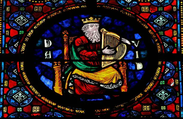 Stained glass window in the Notre Dame church of Dinant, Belgium, depicting the Hebrew king David. This window was created in 1821. No property release is required.