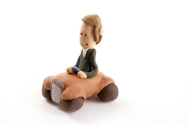 istock Handmade plasticine man driving a car 1342490159