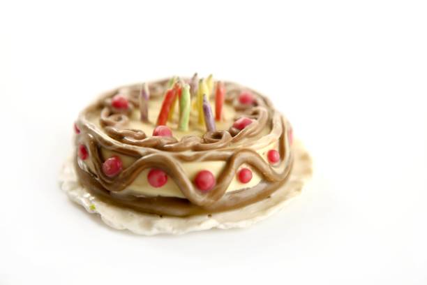 Toy plasticine happy birthday cake isolated over white background