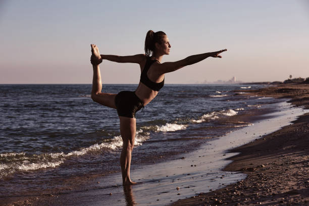 istock Pilates yoga workout exercise outdoor on beach 1342491981