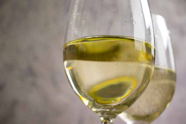 istock glass of white wine grapes on a concrete background 1342492285