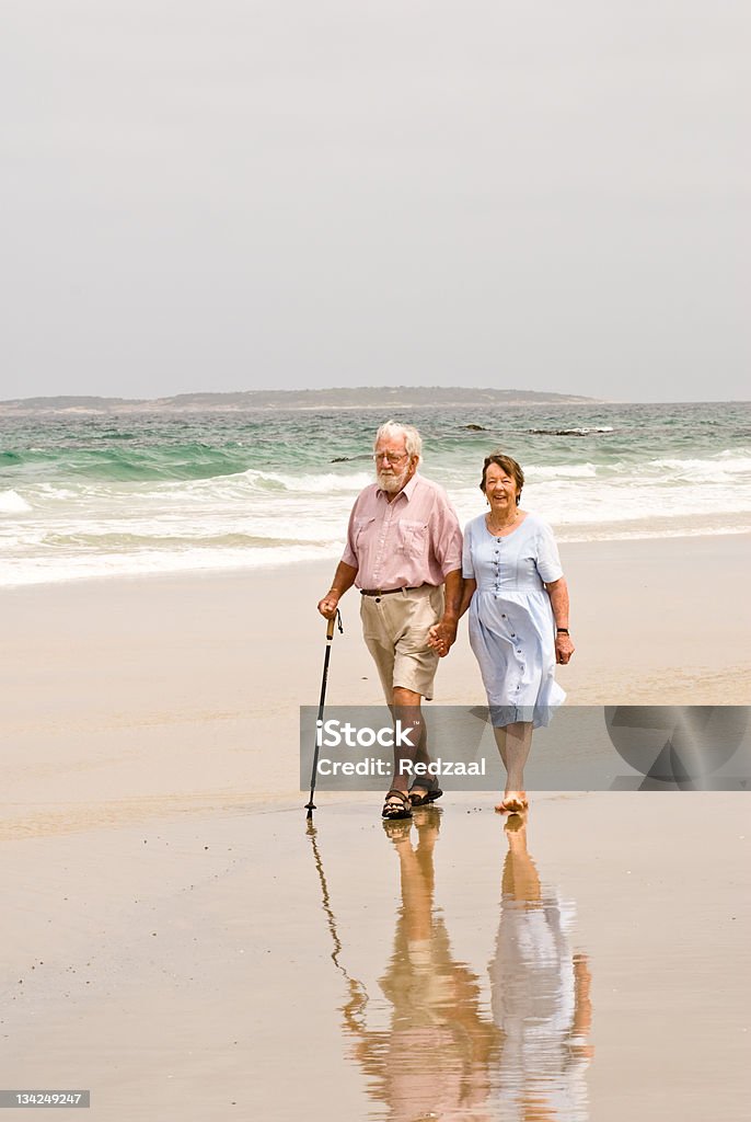 Senior couple walking on beach, East coast, Tasmania, Australia Senior couple in their 80s walking on beach, Tasmania, Australia. Initial Rating 5! Thank you, iStock Senior Adult Stock Photo