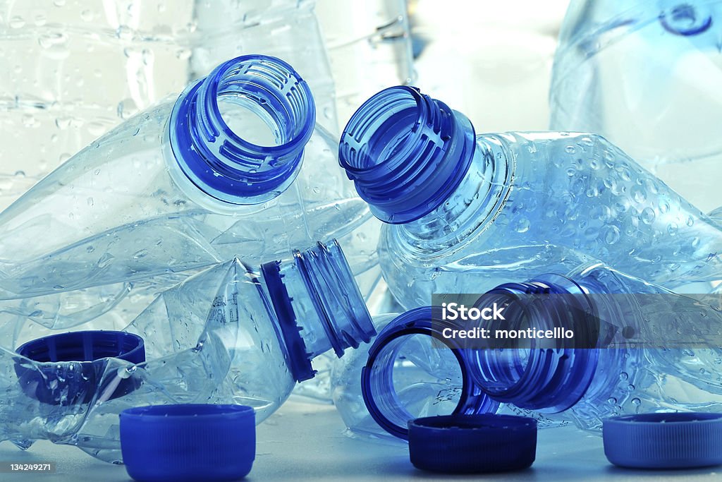 Empty squashed plastic bottles with no labels Composition with plastic bottles of mineral water. Plastic waste Container Stock Photo