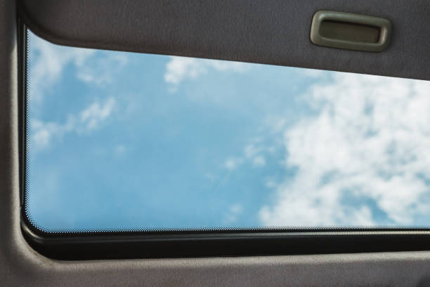 istock Open sunroof and deep blue sky 1342493418