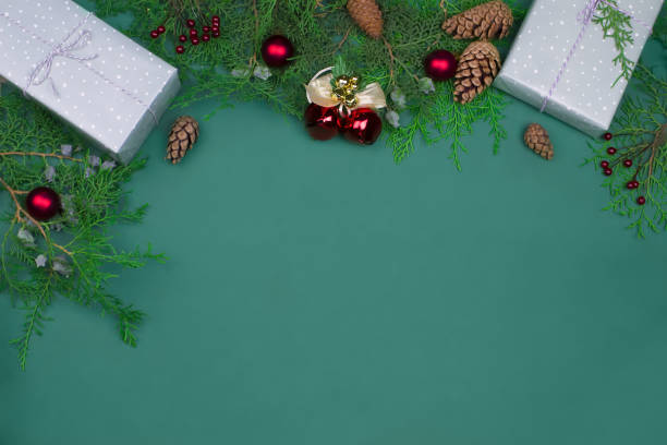 istock Gift boxes, pine cones, fir branches and New Year's decor on a green background with copy space. 1342495813