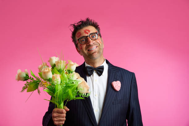 Nerd man with lipstick marks on face in Valentines Day and flowers
