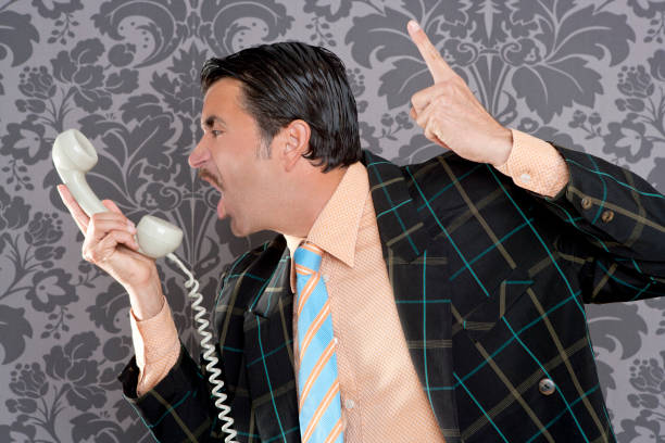 istock Angry nerd businessman retro telephone call shouting 1342497147