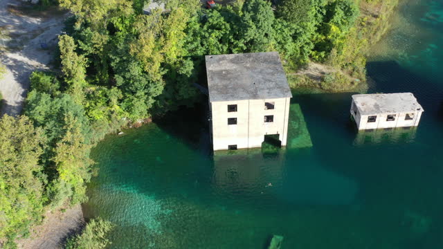 An aerial view of abandon buildings partially submerged in the waters of an old quarry in Verplanck New York.